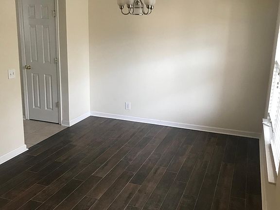 Dining room looking from front door. You can see the door to the pantry in the kitchen.