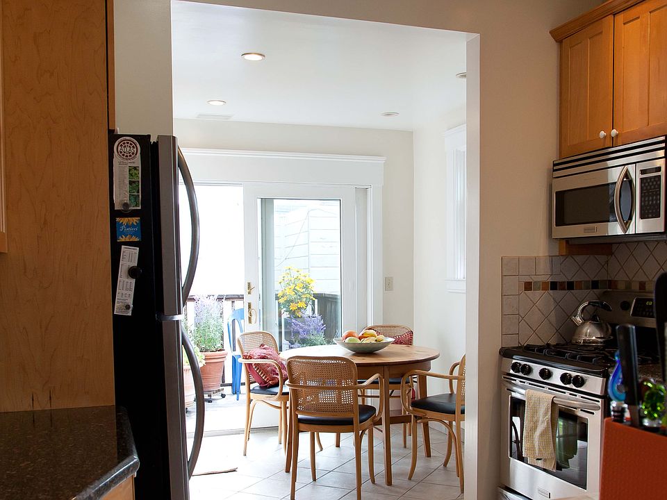 Wider angle of kitchen - stainless steel appliances. Walk out deck. Window above sink. In unit washer dryer (not pictured).