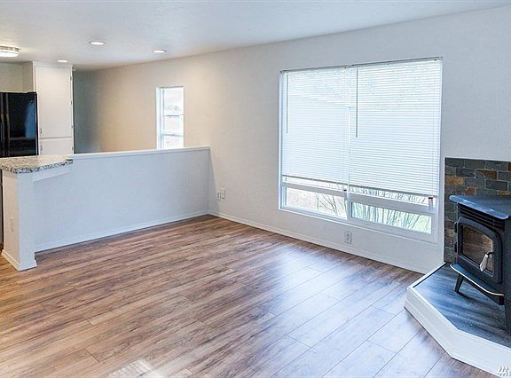 Attractive Great Room...Rich laminate floors, new vinyl windows, pellet stove with slate surround.