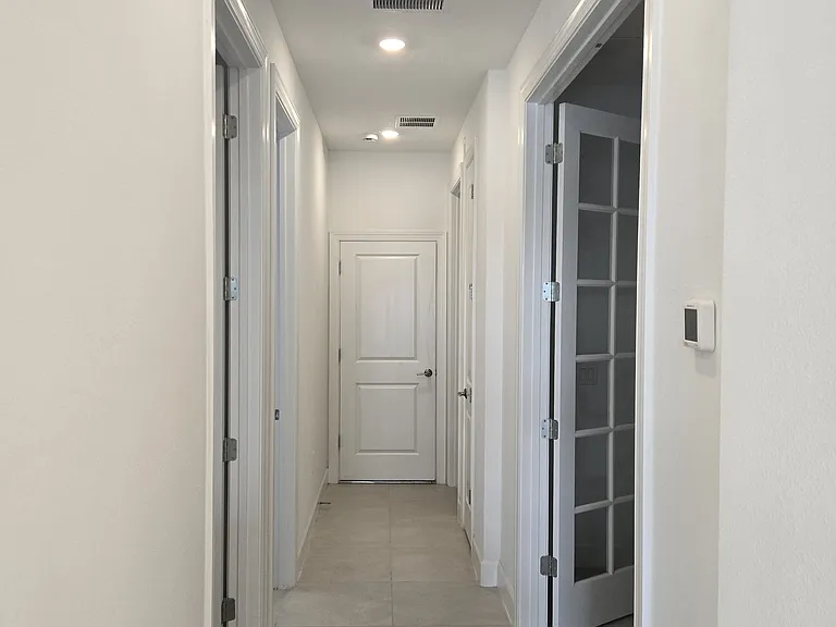 Hallway to flex room, 2nd bedroom, laundry room and garage