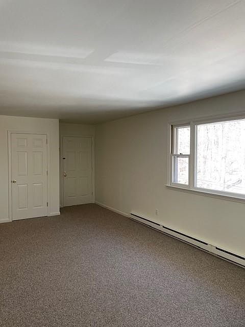 Living/dining area, coat closet, front door - kitchen is to the left of the closet