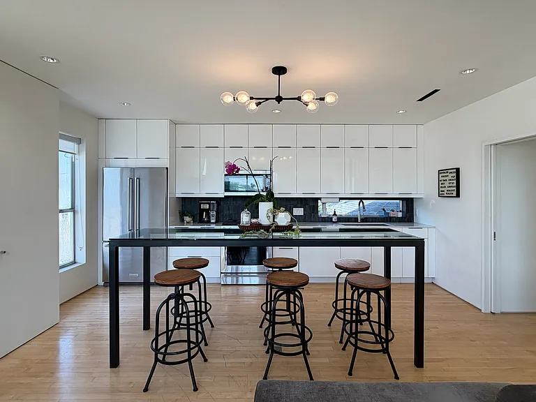 Designer fixtures, recessed LED, and art lighting throughout.