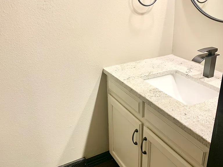Main Level 1/2 Bath- New granite, sink, faucet and mirror.