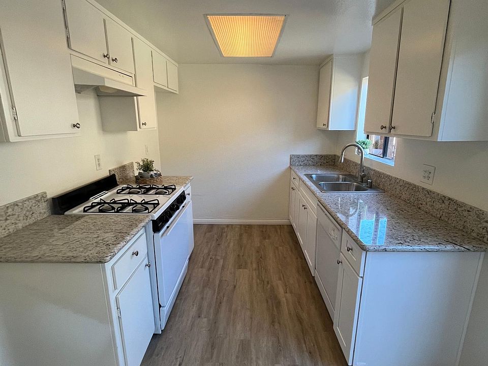 Newly renovated kitchen with new counters, sink, faucet and cabinets.
