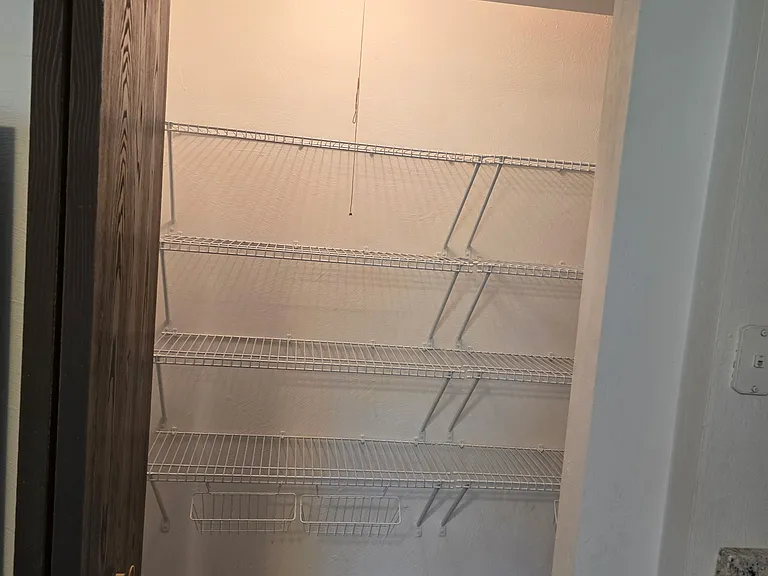 The kitchen features a pantry that offers ample storage space