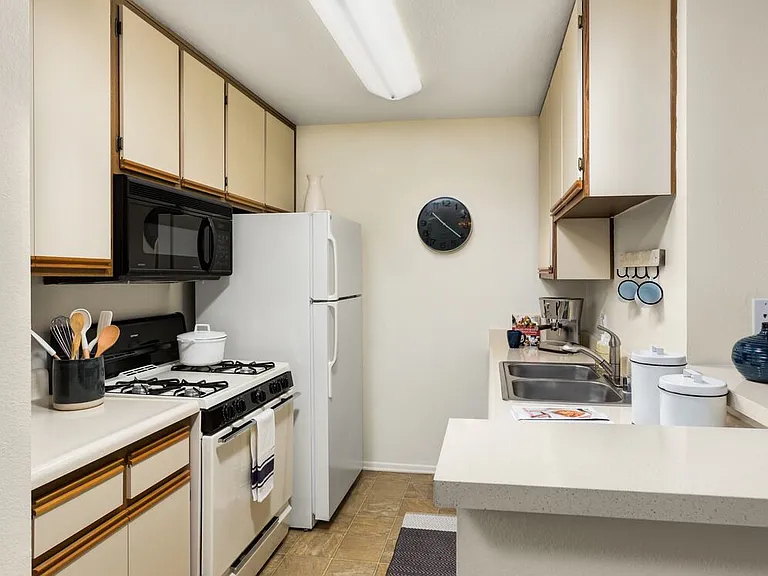 Classic I kitchen with white-on-white appliances and breakfast bars
