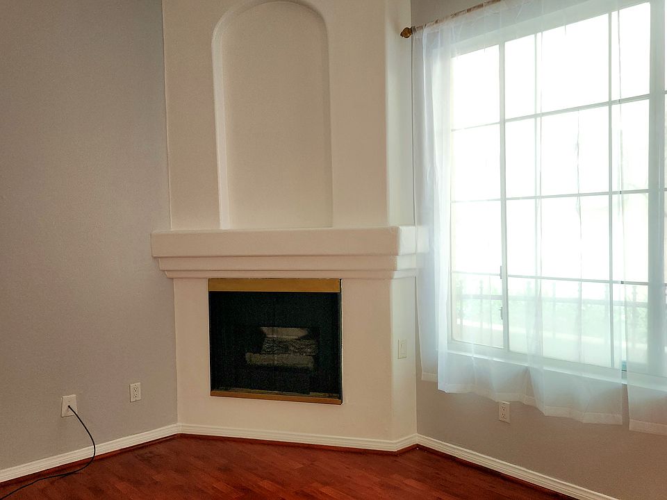 Fireplace near living room window.