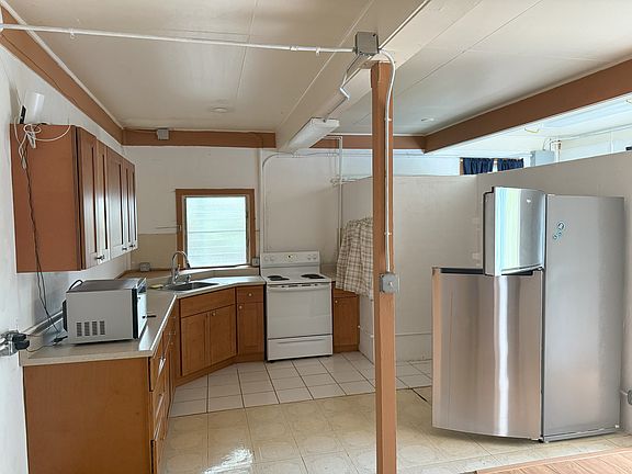 Partly Furnished Kitchen includes refigerator, electric range, microwave