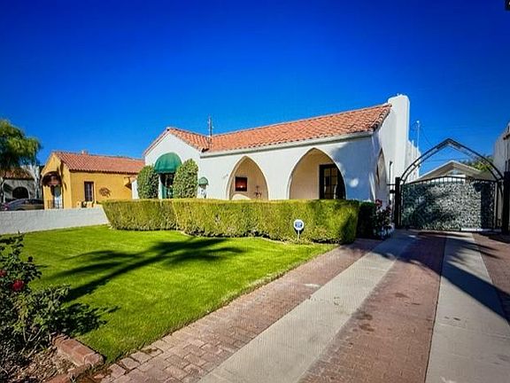 Covered carport behind remote activated security gate.