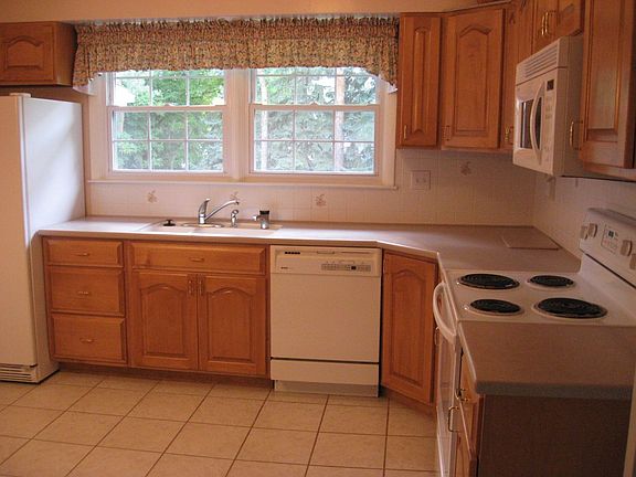 Updated kitchen with Corian countertops & ceramic tile flooring 