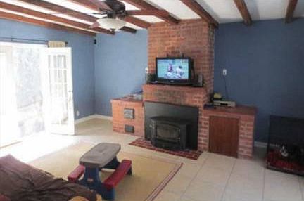 Enclosed patio/den/playroom with wood stove, french doors to patio