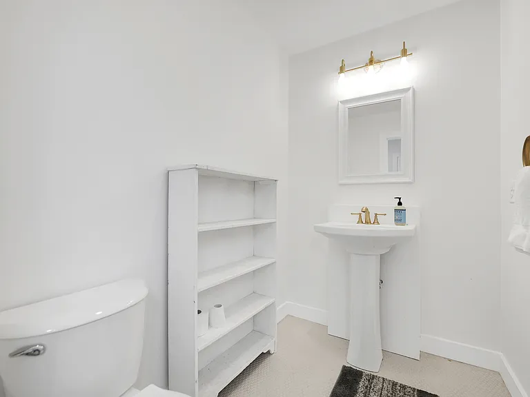 Half bathroom on second level adjacent to living room and kitchen