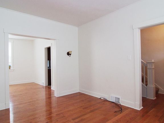 Living room with entry hallway to the right and the dining room to the left.