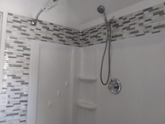 extention on shower rod gives more space to shower