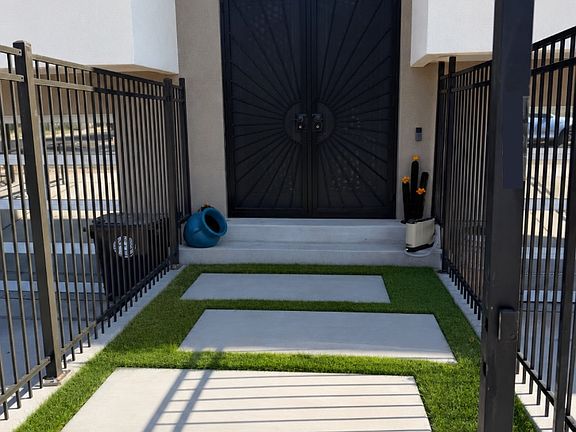 Frontyard Walkway. Not pictured are freshly planted ivy vines growing in the corners of the fencing.