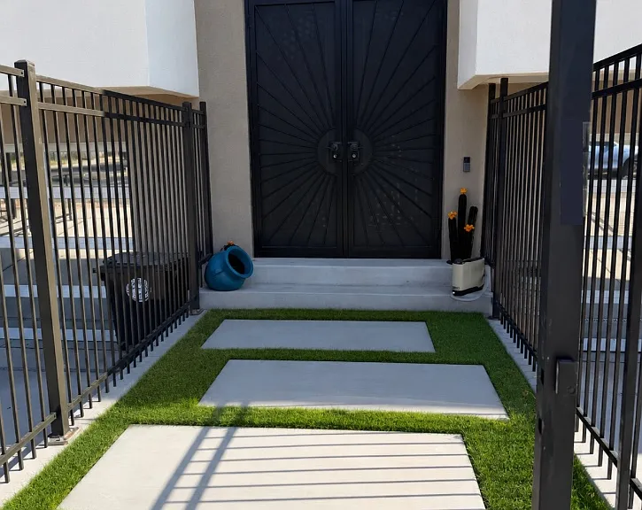 Frontyard Walkway. Not pictured are freshly planted ivy vines growing in the corners of the fencing.