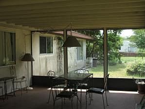 Back of home from spacious screened in porch
