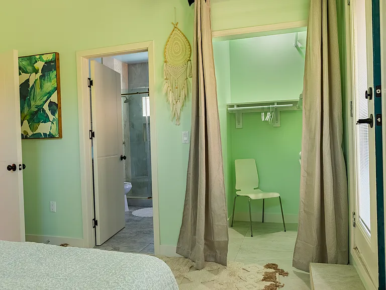 Walk in closet with a three tier closet rods for clothes and storage.
