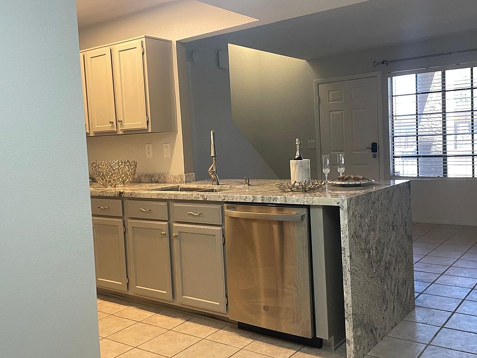 Stainless steel appliances, freshly painted cabinets.
