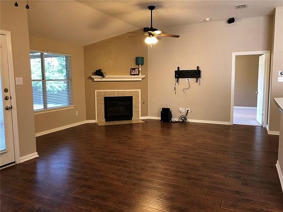 Spacious living room with wood floors and gas log fireplace,