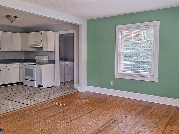 Living area - freshly painted in neutral grey, new flooring and counter top installed (updates not shown here).