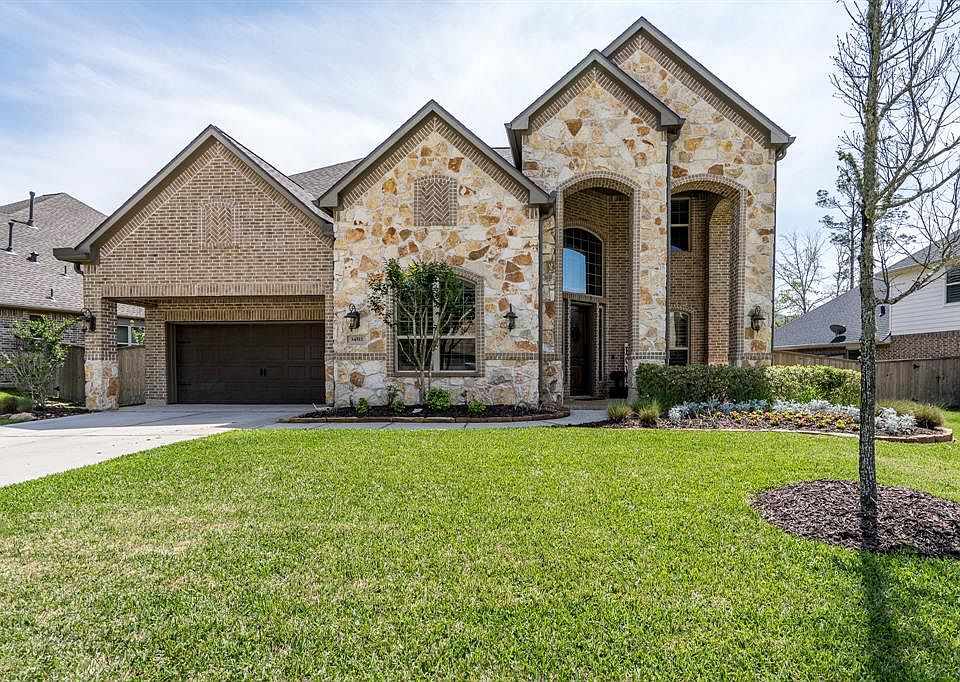 Welcome home to 34511 Spring Creek Circle in the gated master planned community of Woodtrace in Pinehurst, Texas.