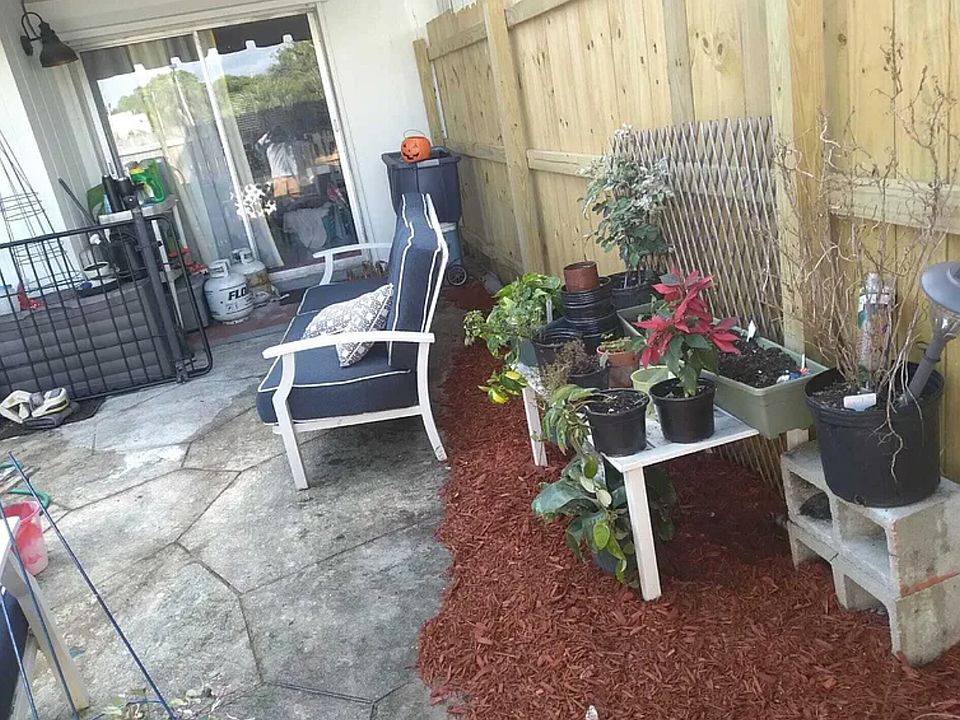 The backyard at 3609 Townhouse Ct, West Palm Beach, FL 33407, offers a private, fenced oasis ideal for outdoor dining, gardening, or relaxation. Residents can enjoy tranquil lake views directly from the backyard, enhancing the serene ambiance.