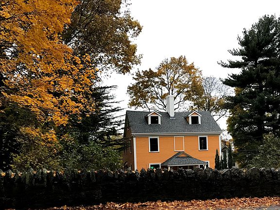 Historic house with unique wall in the front. Large yard.
