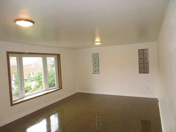 LED lighting fixtures, bay window with new ceramic tile window sill and glass block windows in the living room.