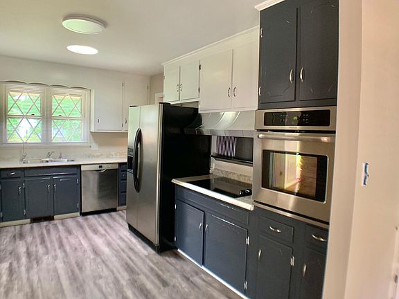 Newly painted kitchen cabinets, new countertops, sink, Bosch dishwasher and smooth top stove. Convenient oven mount wall oven. New vinyl plank laminate flooring is easy to clean.