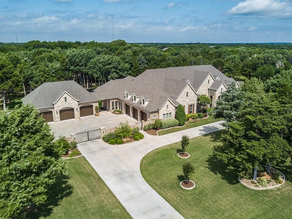 Perfectly placed trees, manicured grounds, private gated motor court and estate style curb appeal