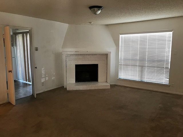 Large living with wood burning fire place!