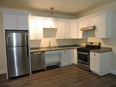 Stainless steel appliances, solid wood cabinets and quartz countertops.