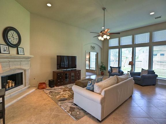Light-filled room with 12 foot ceilings and 20" tile flooring.