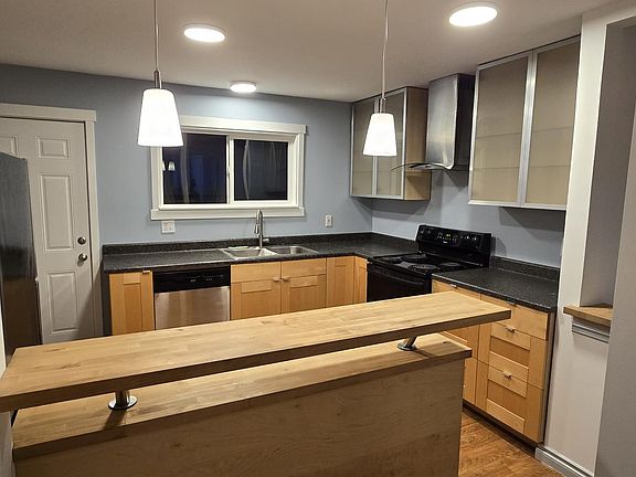 Kitchen from hallway, high counter sitting area.