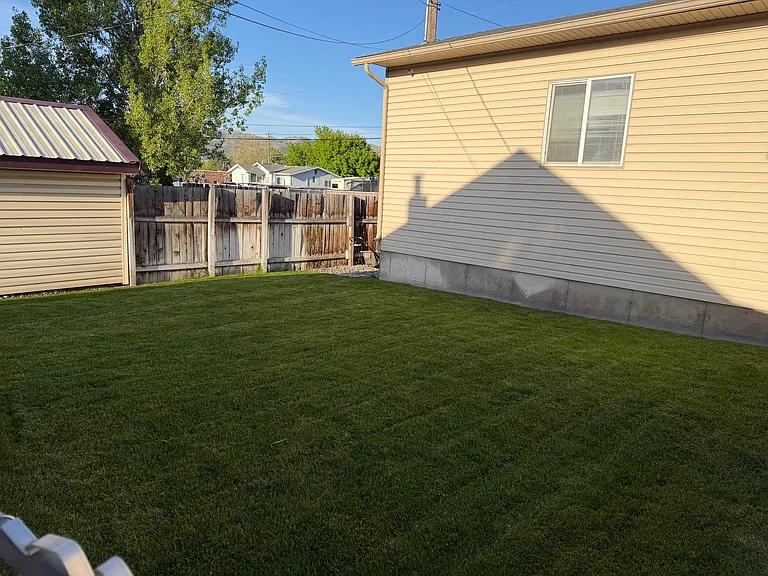 Fenced back yard with sprinkler system