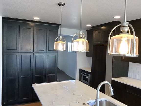 Open kitchen with large island, quartz slab and more