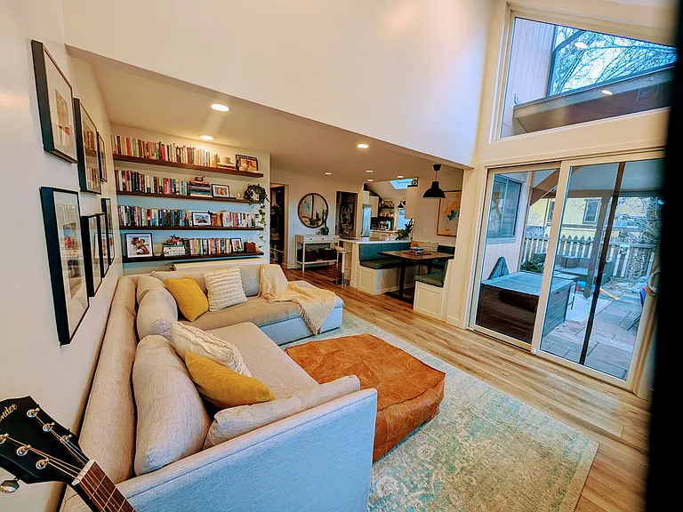 Living area, dining area and access to a large private partially covered patio with open space views.