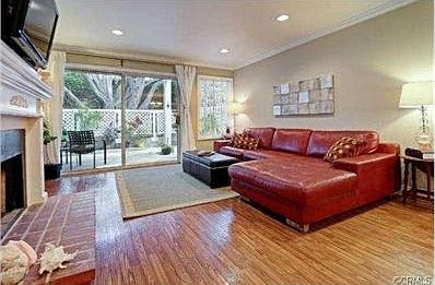 Living room opens onto patio which spans entire southeastern sid