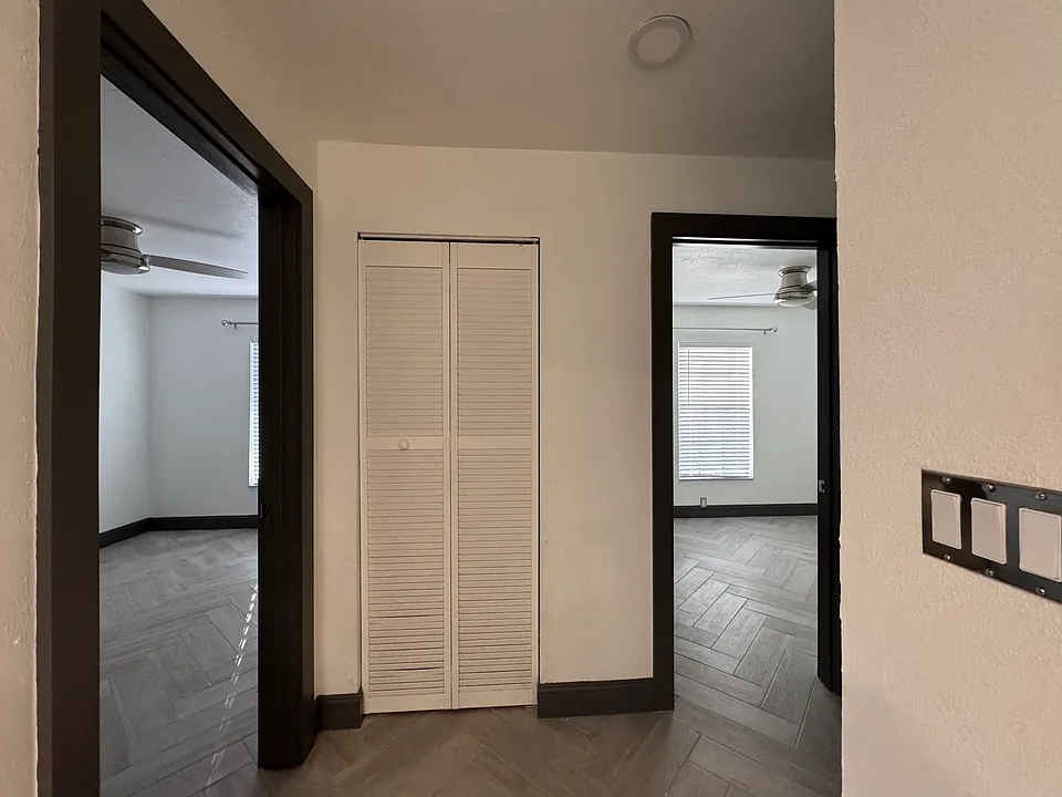 Hallway with the view of the doorway to each of the two bedrooms...front bedroom to the left
