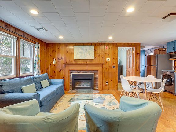 Living room with gas fireplace, CENTRAL AC. Note W/D and fridge in Pantry area.