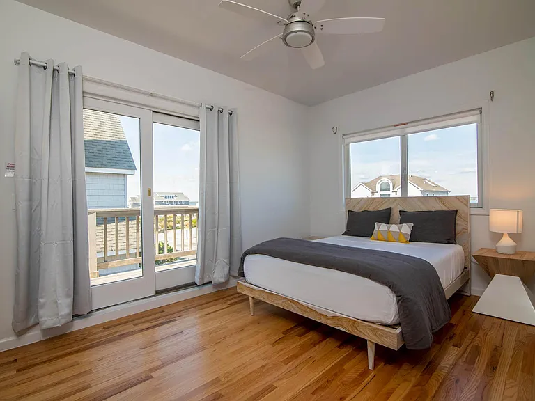 First bedroom with en-suite bathroom, as you come up stairs with bay views. Sliders to deck for ocean and bay view pleasure.