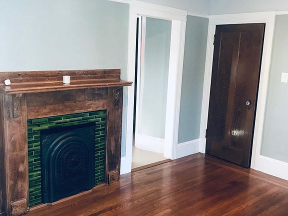 Period fireplace and mantle in dining room.