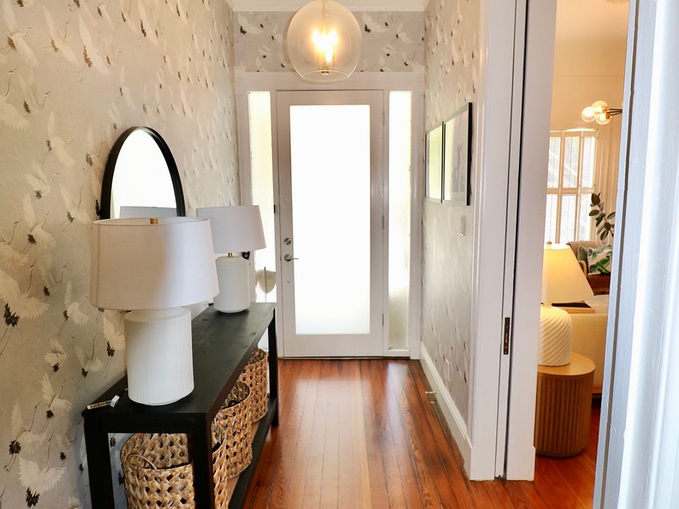 hallway facing the front door living room to the right