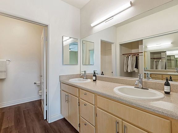 Updated Finishes bath with laminate countertops, oak cabinetry, and upgraded hard surface flooring