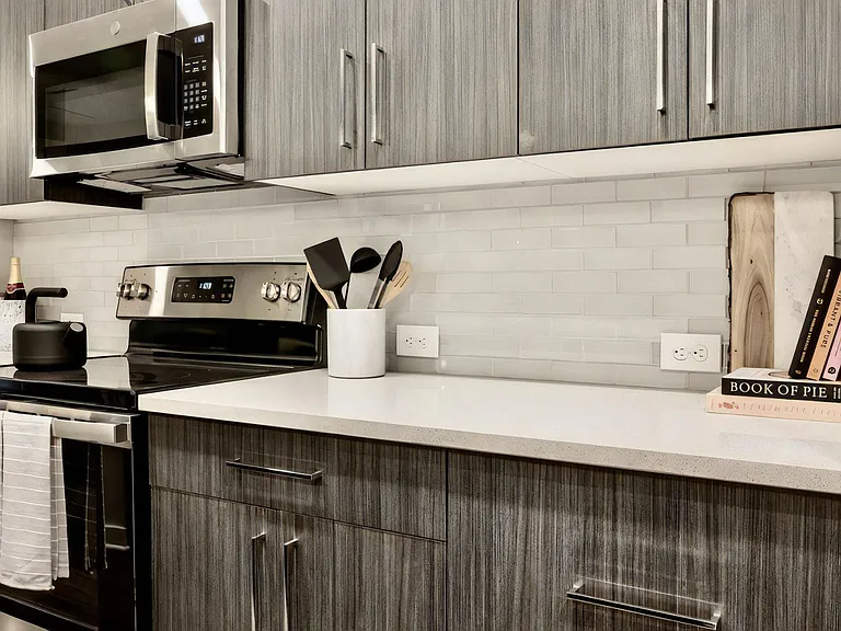 Kitchen Countertop with Cabinets, Books, and Cooking Utensils