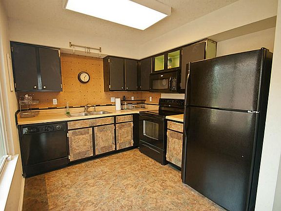 Kitchen with black appliances.