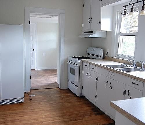 Country kitchen features gas range, stainless side by side f