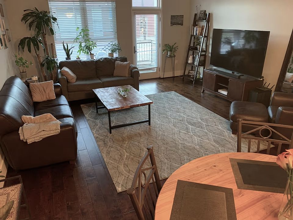 Living room with 2 couches and 70in television