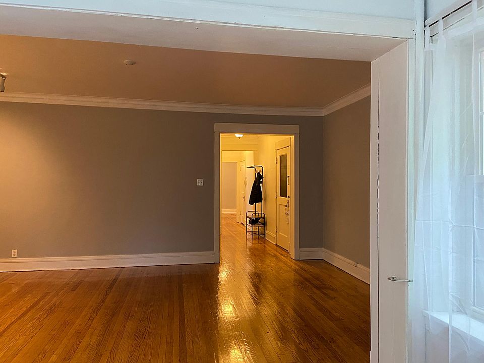 Living room. Front door to the right. Hallway leads to the back of the apartment.